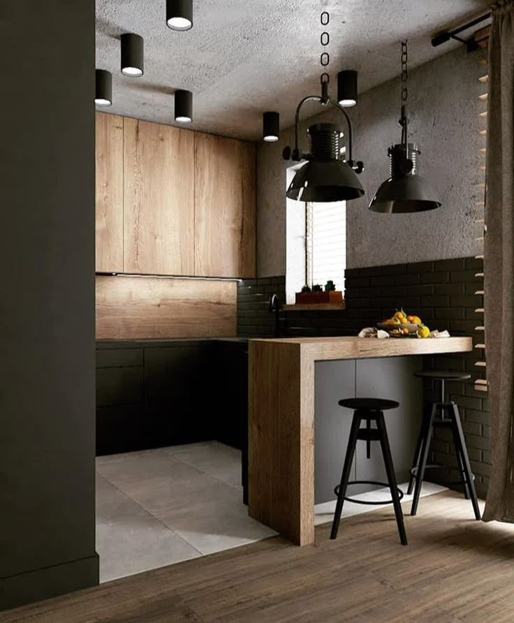 a modern kitchen with black and wood accents is pictured in this image, while the bar stools are also visible