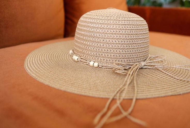 Block the rays in the most stylish of ways! Our BOHEMIAN hat comes in a natural tan woven texture. A straw beaded band tops off the look. Decorate your Summer outfits with a lightweight touch! Measurements: 4” Brim, 3.5” Crown Depth, 7.5” Head Diameter Material: 100% paper Beachy Beige Straw Hat One Size, Beige Beachy Straw Hat, Beachy Adjustable Beige Panama Hat, Summer Beaded Sun Hat For Vacation, Adjustable Beige Straw Hat For Beach, Casual Beaded Fedora Sun Hat, Casual Beaded Straw Hat With Short Brim, Casual Beaded Hats For Beach Season, Casual Beaded Sun Hat For Summer