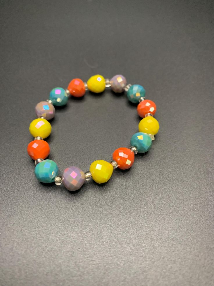 Multi colored beaded bracelet Faceted Beads Stretch Bracelet, Adjustable Multicolor Beaded Crystal Bracelet, Casual Colorful Beaded Jewelry, Yellow Beaded Bracelets With Colorful Round Beads, Colorful Round Beaded Bracelets For Jewelry Making, Yellow Bracelets With Colorful Round Beads, Yellow Bracelets With Colorful Beads, Trendy Silver Beaded Bracelets With Colorful Beads, Adjustable Multicolor Faceted Beads Bracelets