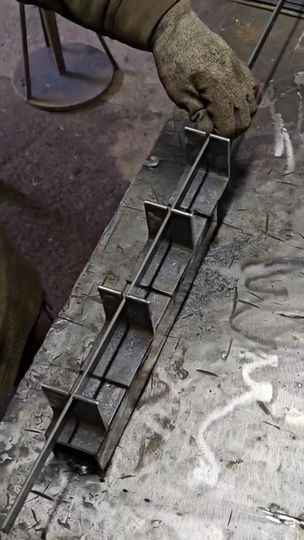 a person is working on some metal bars