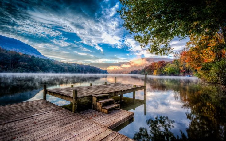 a wooden dock sitting on top of a lake