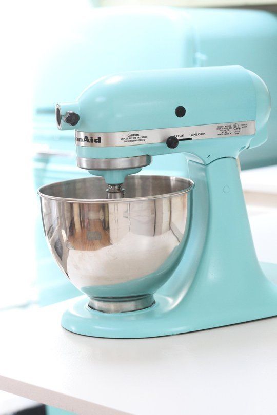 a blue mixer sitting on top of a white counter