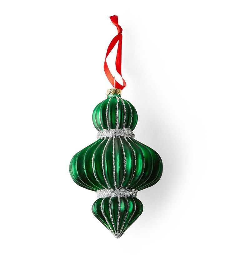 a green ornament hanging from a red ribbon