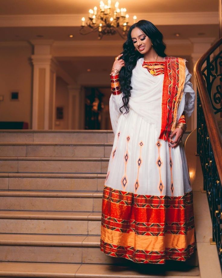 This exquisite Ethiopian Habesha dress is a true masterpiece of traditional craftsmanship. The lower part of the dress is made of Shimena, which is handwoven with great care and attention to detail, resulting in a beautiful and unique texture. The Menen fabric used in this dress is of the highest quality, adding a luxurious feel to the overall design. The neckline and wrists of the dress are adorned with intricate Tilf embroidery, adding an elegant and sophisticated touch to the vibrant colors o Eritrean Dress, Habesha Dress, Habesha Kemis, Traditional Techniques, Modern Style, Dresser, The Dress, Overalls, Hand Weaving