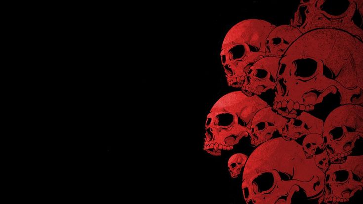 a bunch of skulls that are red and black in the dark, against a black background