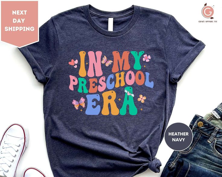 "In My Preschool Era Shirt, Preschool Teacher Shirt, Preschool Vibes T-Shirt, First Day of School, Back to School Shirt, Gift for Teacher ORDERING: 1. Review all photos 2. Choose Size and Color from drop-down menu 3. If personalization box is available, add your text color 4. Add each shirt to cart one at a time 5. Click \"Add to Cart\" - you can go back to add more products 6. Click \"Proceed to Checkout\" 7. Add note to seller for any requests * We use several different brand shirts, all of th Blue Letter Print Shirt For School, Name Print T-shirt For Daycare With School Spirit, Blue T-shirt For School, Blue Letter Print Shirt For School Events, Blue Graphic Print Top For School Events, Cute Blue T-shirt For End Of School Year, Blue T-shirt With Name Print For School, Blue Cotton T-shirt For School Events, First Day Of The School