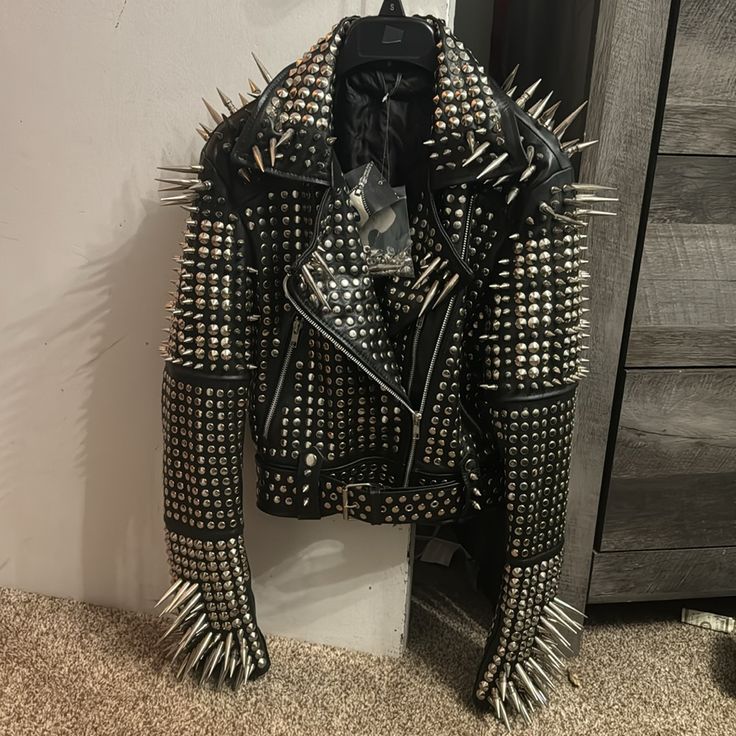 This Jacket Has Huge Spikes And Studs All Over It. It’s A Size Small, And It’s Brand New With Tags Still Attached. I Paid $600 For It. Reasonable Offers Only, Item Weighs 12lbs. Extra Spikes And Studs Are Included In Case You Lose One. Real Leather And Stainless Steel Studs And Spikes. This Coat Is Brand New And Hasn’t Even Been Worn. There Are No Flaws, Rips Or Anything. This Is New. Sleeves Do Have Zippers This Item Fits A Size 2-4 Measurements: Shoulders: 15.5” Chest: 35” Waist: 30” Hips: 36” Studded Leather Jacket For Party, Studded Winter Party Outerwear, Studded Winter Outerwear For Party, Studded Outerwear For Streetwear, Party Outerwear With Rivets, Designer Winter Outerwear With Rivets, Party Outerwear With Studs And Long Sleeves, Black Party Outerwear With Rivets, Fitted Studded Winter Outerwear