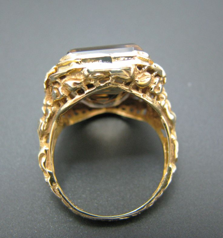 "PRE-OWNED For Sale: (1) Beautiful Vintage Emerald Cut Smokey Quartz Mounted in a 14k Yellow Gold Ring PLEASE READ ENTIRE DESCRIPTION BEFORE PURCHASING Please see pictures for more details! This is a lovely emerald cut smokey quartz ring in 14k yellow gold filigree mounting with bows on each side. The embossed filigree design does cover the whole ring band. This ring is stamped 14k. A very nice ring. Specifics: 14k Yellow Gold Smokey Quartz approx. 16 mm x 11.3 mm Size: 7 Weight - 5.8 grams If y Victorian Emerald Cut Jewelry For Formal Occasions, Heirloom Yellow Gold Wedding Ring For Formal Occasions, Antique Round Cut Formal Jewelry, Victorian Style Engraved Ring With Polished Finish, Antique Jewelry With Polished Finish For Anniversary, Antique Yellow Gold Jewelry For Anniversary, Victorian Emerald Cut Formal Jewelry, Victorian Style Formal Engraved Ring With Polished Finish, Heirloom Gold Engraved Ring For Formal Occasions