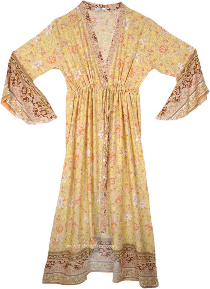 This exquisite kimono dress is crafted from soft, spun rayon, featuring a floral pattern in gentle hues of peach, yellow, and brown.  The design offers a deep V-neckline, wide sleeves, and a flowing skirt that falls gracefully to the ankles. #tlb #vacationclothing #beachwrap #Fall #Floral #Printed #bohemianfashion #XLPlus #SummerDress #westerndress Floral Print V-neck Kimono For Brunch, V-neck Floral Print Kimono For Brunch, Yellow V-neck Boho Dress For Spring, V-neck Floral Print Kimono For Fall, Yellow Bohemian Kimono With Kimono Sleeves, Bohemian Dress With Kimono Sleeves For Fall, Bohemian Fall Dresses With Kimono Sleeves, Yellow Floral Print Maxi Dress For Festival, Yellow Boho Print Maxi Dress For Spring