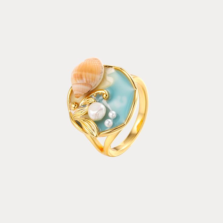 Bring the captivating beauty of the sea to your fingertips with the Ocean Shell Ring. Designed with lustrous gold-plated metal, this exquisite ring features an intricate shell-inspired design that evokes the natural wonder of a coastal retreat. Delicate yet bold, this enchanting accessory lends an air of stylish glamour, effortlessly elevating any outfit with its alluring oceanic inspiration. DETAILS Plating: 18K Gold Materials: 18K Gold on Brass, Dripping Oil, Pearl Diameter: 0.71"(1.8cm)   UK( Gold Ocean-inspired Rings For Beach, Ocean-inspired Shell-shaped Rings As Gift, Elegant Shell-shaped Gold Rings, Elegant Gold Shell-shaped Rings, Gold Shell-shaped Ring For Gift, Gold Shell-shaped Gift Ring, Elegant Shell-shaped Ring For Gifts, Gold Enamel Open Ring For Wedding, Gold Open Ring Enamel Wedding Ring