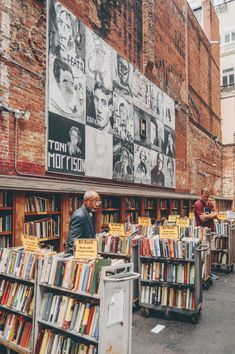 an old man standing in front of a book store