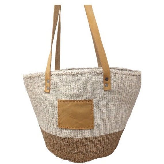 "- Measurements - 10\" Inches length x 10\" Inches Depth  and 16\" Inches Tall (with handles) - Brown suede leather straps - Has inside lining and inner pocket - Includes FREE shipping in the US basket bag leather handles, woven bag, sisal bag, woven bag with handles, woven basket bag with strap, colorful woven bag, woven summer bag Description: A popular choice for the eco-conscious shopper, this natural baskets bags would make a great impressive gift since they are  one of a kind woven item. T Rectangular Cream Straw Bag With Woven Leather, Cream Rectangular Woven Leather Straw Bag, White Natural Fiber Travel Bag, Top Handle Jute Bag With Woven Leather, Top Handle Woven Jute Bag, Top Handle Woven Jute Shoulder Bag, Top Handle Jute Shoulder Bag With Woven Details, Woven Leather Top Handle Jute Bag, Woven Jute Shoulder Bag With Top Handle