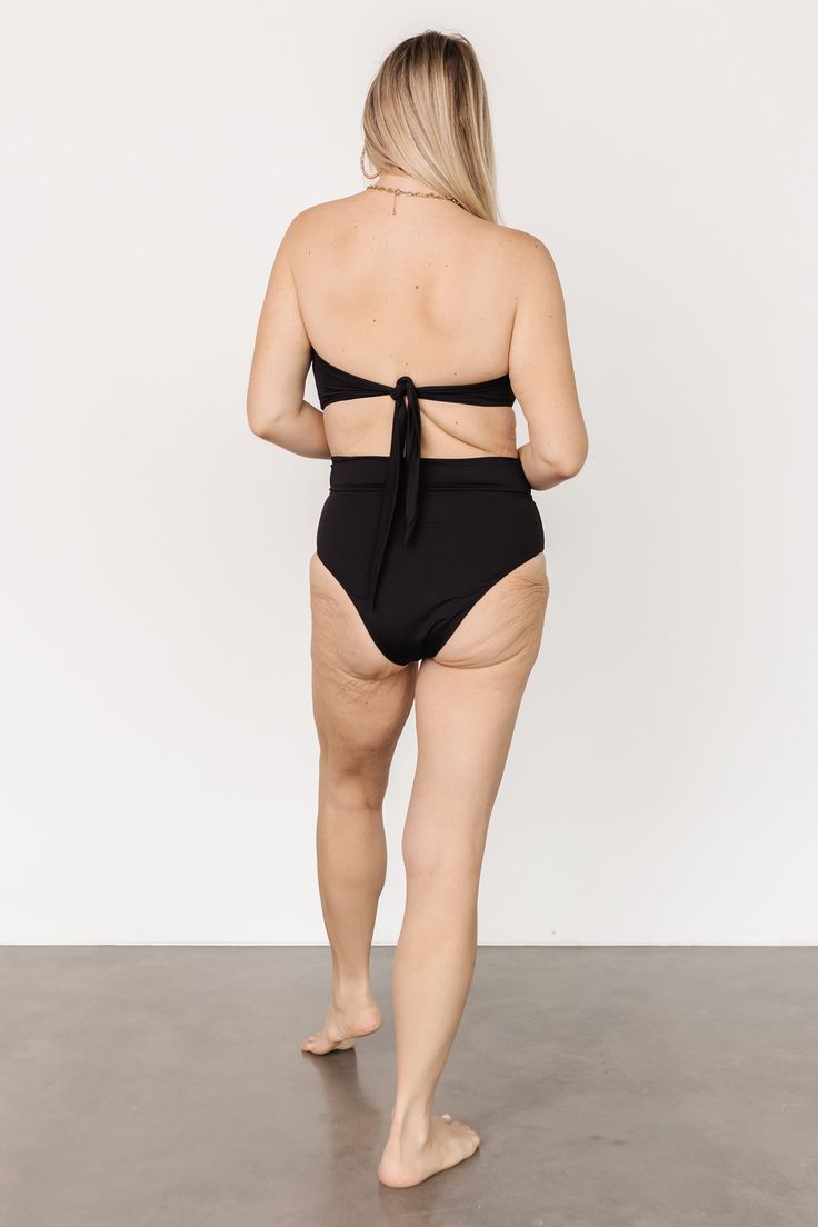 Baltic Born best-seller! Classic Black High waist style bikini bottom Adjustable front wrap tie detail Moderate coverage 80% Nylon, 20% Spandex Hand wash cold Trina is 5'6, cup size 32D, size 2 and is wearing size S Victoria is 5'7, cup size 34D, size 8/10 and wearing size L Beachwear Tankini With Built-in Bra And High Waist, High Waist Swimwear With Built-in Bra For Pool, Fitted Swimwear With Built-in Bra And Tie-side Bottom, Tie-side Bottom Swimwear With Built-in Bra For Sunbathing, Chic High-waisted Swimwear For Poolside, Chic High Waist Swimwear For Poolside, Chic High-waisted Poolside Swimwear, Chic Seamless Beach Bottoms, Beach Bottoms With Bra-friendly Tie-side