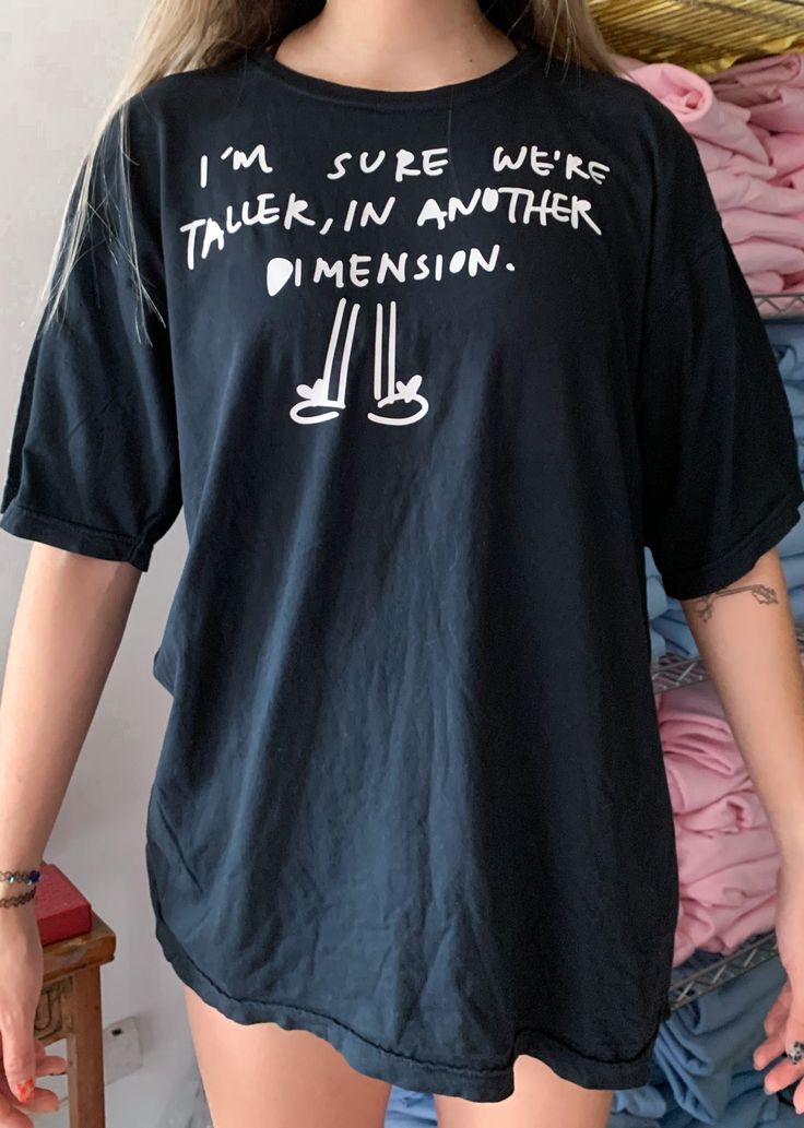 ✰I'm Sure We're Taller in Another Dimension✰UNISEX✰Hand drawn and designed✰Super soft and comfy!✰Model is 5'8 and wearing Size L T shirt Im Sure Were Taller In Another Dimension, Funny Relaxed Fit Text Print Tops, Funny Slogan Tops With Relaxed Fit, Black Relaxed Fit Funny Tops, Relaxed Fit Cotton Tops With Cartoon Print, Relaxed Fit Cotton Top With Cartoon Print, Cotton Tops With Cartoon Print In Relaxed Fit, Funny Cartoon Print Relaxed Fit T-shirt, Oversized Funny Crew Neck Top