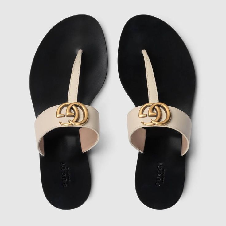 Shop the Leather thong sandal with Double G by Gucci. An emblem of the GG Marmont line, the Double G is an archival play on the original Running G, a belt buckle that first appeared in Gucci collections in the 70s. For Pre-Fall 2018, the antique gold-toned detail defines a pair of flat white leather thongs. Gucci Sandals, Leather Thong Sandals, Gucci Leather, How To Make Shoes, Womens Slides, Sport Sandals, Tory Burch Miller Sandal, Designer Sandals, Gucci Shoes