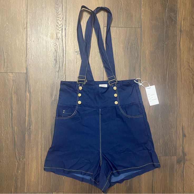 Nwt Unique Vintage Blue Denim Retro Pinafore Shorts 1x Pinafore Shorts Blue Denim Bengaline. Banded Waistline Retro Silhouette, While The Suspenders Are Adjustable 65% Rayon, 30% Nylon, 5% Spandex Unlined, Side Zipper, Hook Adjustable Suspenders Side & Back Pockets Material Has Stretch F Utility Denim Bottoms With Bib Front, Utility Denim Bib Front Bottoms, Utility Bib Front Bottoms In Medium Wash, Medium Wash Bib Front Utility Bottoms, Spring Denim Bib Front Bottoms, Blue Utility Shortalls For Spring, Non-stretch Medium Wash Overalls, High Waist Denim Jumpsuit With Pockets, Medium Wash Non-stretch Overalls