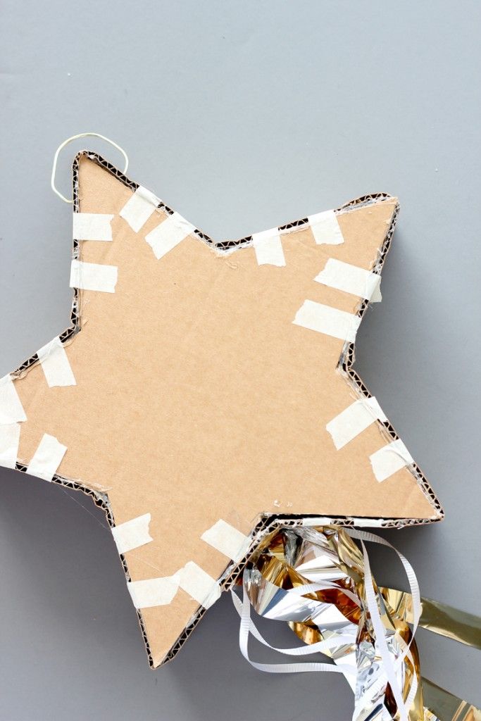 an ornament made out of cardboard and ribbon