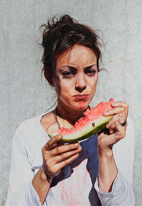 a woman eating a piece of watermelon with her face smeared