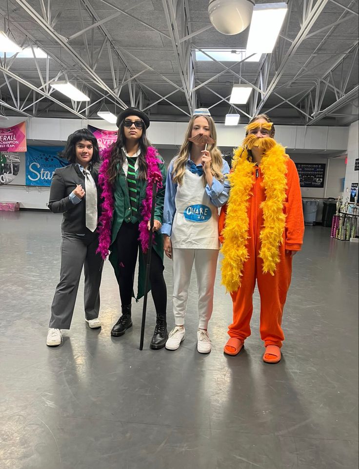 four people in costumes posing for a photo