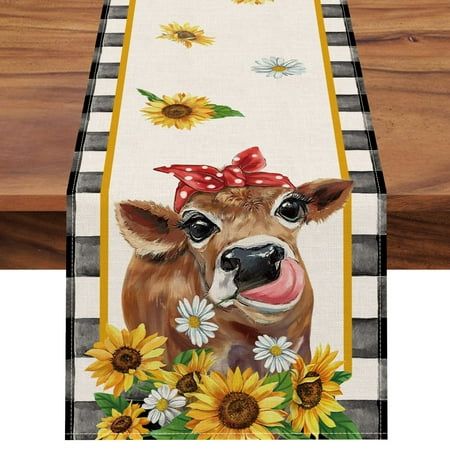 a painting of a cow with sunflowers on it's head and tongue sticking out