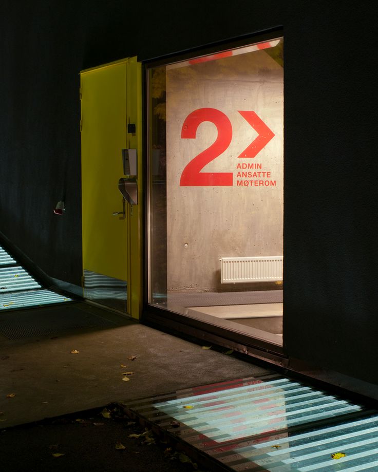 an open door with the number twenty two on it in front of a black wall