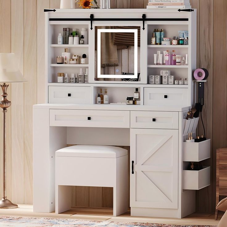 a white vanity with a mirror and stool in front of it on top of a wooden floor