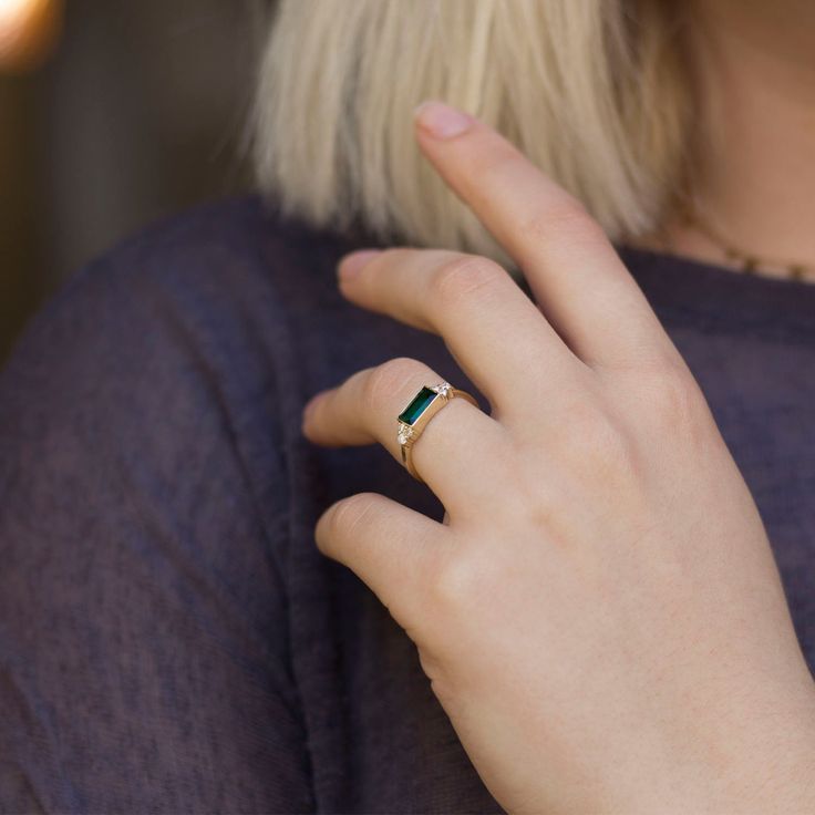 "Handmade by an inspired jewelry artist team with decades of experience in the craft of jewelry making. Each gemstone, each diamond is carefully picked. Using only the finest raw materials and the highest industry standard in manufacturing, design and finish. Sleek and sophisticated baguette Emerald and diamond ring. This rings dainty nature adds to its charm, the green emerald is set to show its depth and magnificent colors through out. The emerald is highlight perfectly with six round diamonds Modern Emerald Cut May Birthstone Jewelry, Minimalist 14k Gold Emerald Cut Jewelry, Everyday Prong Setting Ring, Modern Emerald Rings With Baguette Cut, 14k Gold Baguette Cut Promise Ring, Minimalist Diamond Ring With Prong Setting For May Birthstone, Minimalist Emerald Diamond Ring For May Birthstone, Minimalist Birthstone Ring With Baguette Cut Gemstone, Everyday Emerald Ring Fine Jewelry