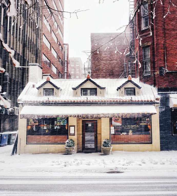 a small store in the middle of a snowy street