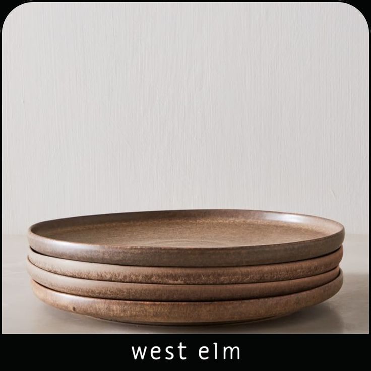 four wooden plates stacked on top of each other