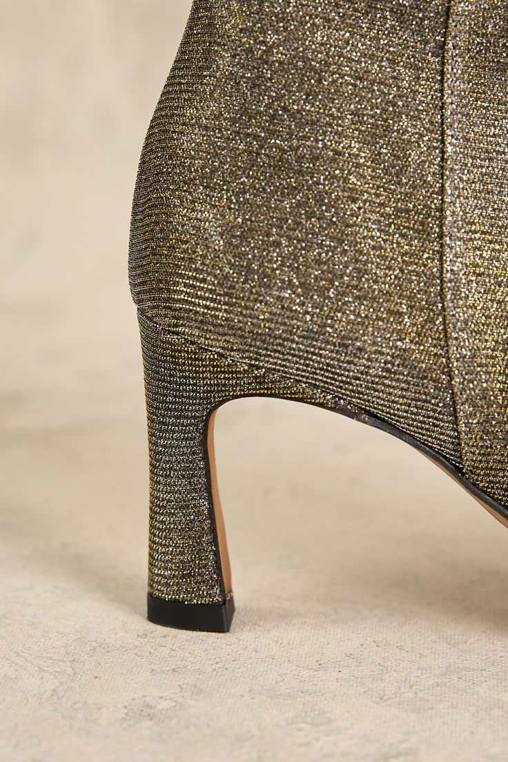 Sparkle and shine in our mesmerising Silver and Gold Metallic Ankle Boot. Crafted in Spain, these ankle length boots are designed to catch the light just so. Featuring a trendy pointed toe, side zip fastening and stable heel, dress up your look with metallic shimmer. Gold High Ankle Boots For Party, Gold High Ankle Party Boots, Winter Party Heels With Low Heel, Winter Party Low Heel Shoes, Glamorous Gold Heeled Boots For Party, Elegant Glitter Fitted Boots, Elegant Fitted Glitter Boots, Gold Ankle-high Boots For Evening, Pointed Toe Party Booties For Spring