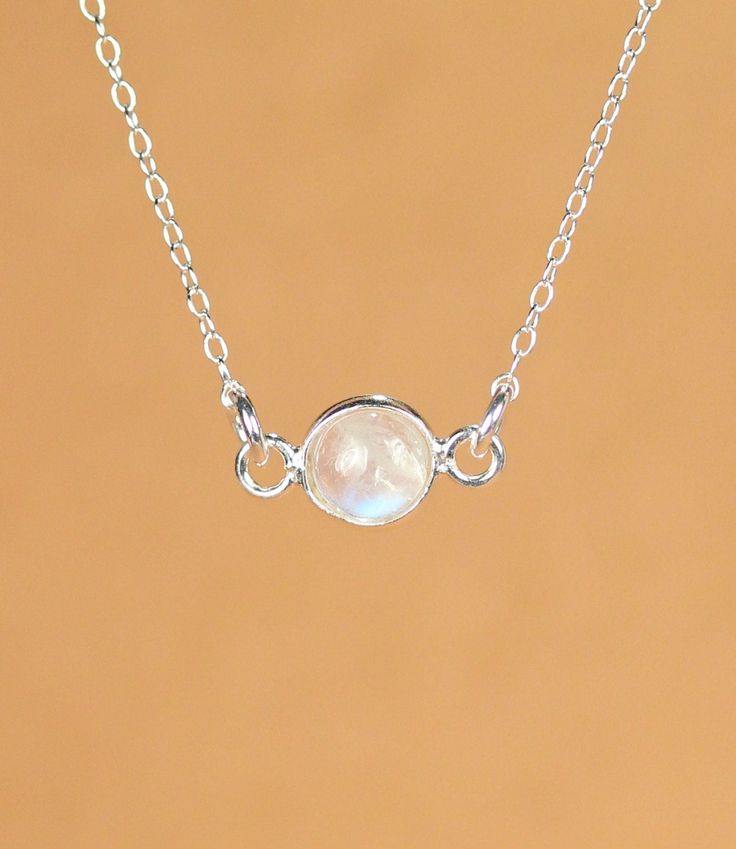 Moonstone necklace - silver moonstone - june birthstone - rainbow moonstone - a silver bezel set moonstone on a sterling silver chain A beautiful, one of a kind, silver lined rainbow moonstone, hanging horizontally from a 16 inch sterling silver chain. Please feel free to select a different length chain if you prefer! I took multiple photos in different light to show all the possible colors of this gem. Moonstones reflect at different angles and all sorts of light. Need a few reasons to love a m White Moonstone Necklace With Delicate Chain, White Delicate Birthstone Necklace, Delicate White Birthstone Necklace, White Sterling Silver Birthstone Necklace, Minimalist White Necklace With Bezel Setting, Delicate Silver Necklace With Bezel Setting, Delicate Silver Bezel Setting Necklace, Dainty White Round Birthstone Necklace, Minimalist White Gemstone Birthstone Necklace