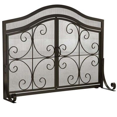 an iron fireplace screen with scroll designs on the top and bottom panels, in black