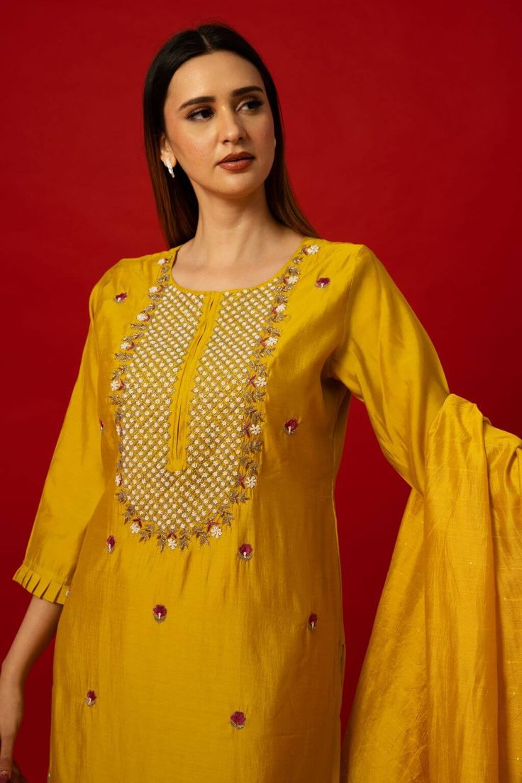 Elevate your wardrobe with the Yellow Silk Kurti Set. This set stands out with its intricate embroidery work. It transcends seasonal trends, offering versatility for various occasions. Whether it's a family gathering, festive celebration, or formal event, the Yellow Silk Kurti Set ensures you stand out with elegance. Its timeless appeal guarantees it as a cherished piece in your collection for years to come. Embroidered Slub Silk Palazzo Set For Navratri, Embroidered Silk Palazzo Set For Navratri, Art Silk Sharara With Floral Embroidery And Straight Kurta, Embroidered Slub Silk Palazzo Set, Embroidered Slub Silk Sharara For Navratri, Embroidered Slub Silk Palazzo Set With Traditional Drape, Festive Slub Silk Sharara With Dabka Work, Traditional Slub Silk Palazzo Set With Resham Embroidery, Embroidered Raw Silk Palazzo Set With Traditional Drape