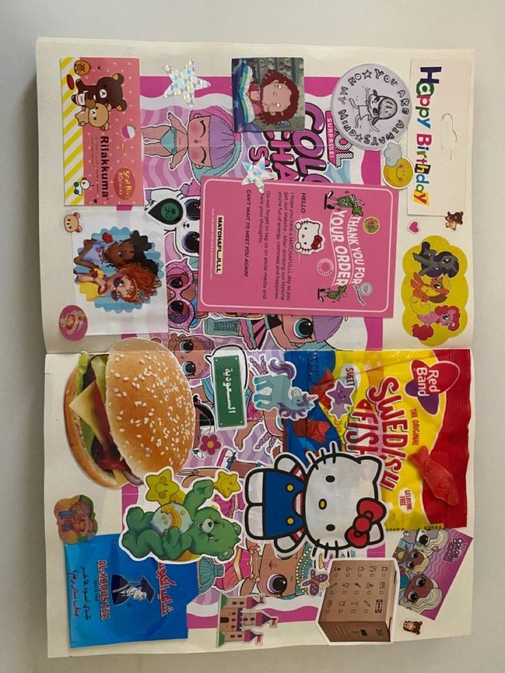 an assortment of hello kitty stickers on top of a piece of paper that is cut in half