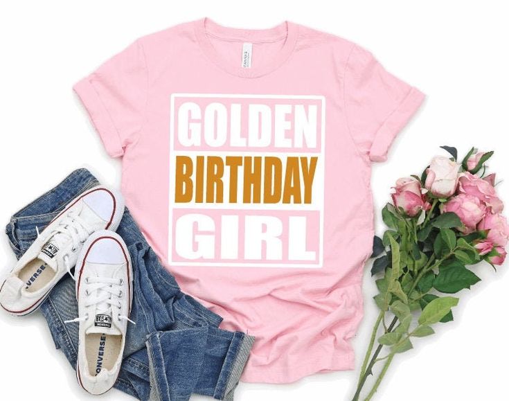 "Golden Birthday Girl Shirt - Girls Golden Birthday Shirt  Gold Birthday Shirt - Golden Girl Birthday Shirt - Personalized Golden Birthday  The perfect T Shirt to Celebrate your Girl's Golden Birthday! The t shirt will be Light Pink as shown in the main photo unless another color is requested from the color chart in the photos. You can choose to add a Name and/or Age to the back of the shirt from the \"Style\" drop down menu. \"BIRTHDAY\" will be printed in a  Gold font, and Golden Girl printed Golden Birthday Shirt, Flower Girl Shirts, Book Nerd Shirts, Gold Font, Bookworm Shirt, Golden Birthday, Birthday Boy Shirts, Birthday Girl Shirt, Flower Girl Gifts