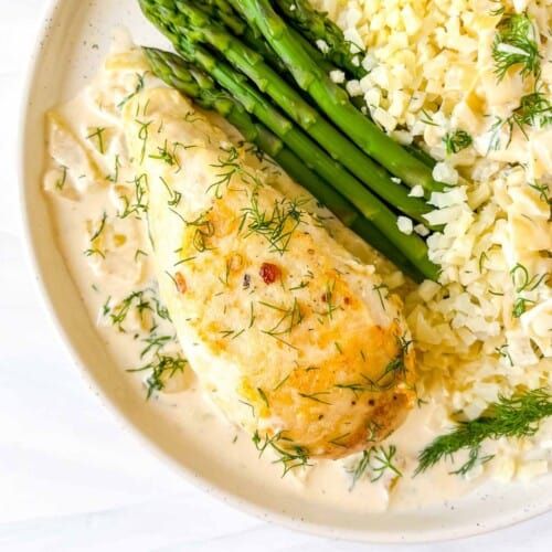 a white plate topped with rice and asparagus