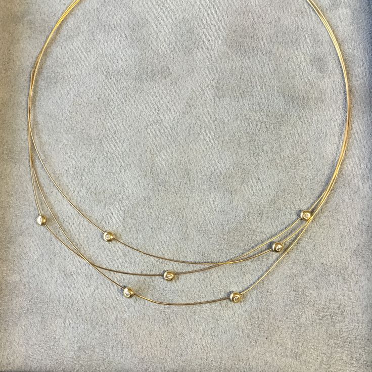 A rare find, this beautiful elegant diamond necklace is made of 3 strand of snake chain set with 7 brilliant cut diamonds in total. Made of 18k yellow gold, the diamonds are set in a round rub over setting. At 16 inches long the necklace will sit at the base of the neck and is commonly know as a choker necklace. The diamond quality is F colour, VS1 clarity. The necklace is secured with a barrel twist and clip lock catch. Luxury Multi-strand Yellow Gold Jewelry, Elegant Multi-strand Yellow Gold Jewelry, Elegant Yellow Gold Multi-strand Jewelry, Elegant Multi-strand Jewelry For Anniversary, Elegant Multi-strand Necklace For Anniversary, Yellow Gold Multi-strand Necklaces For Formal Occasions, Fine Jewelry Yellow Gold Diamond Choker Necklace, Elegant Multi-strand Clavicle Chain Choker, Yellow Gold Diamond Choker Necklace