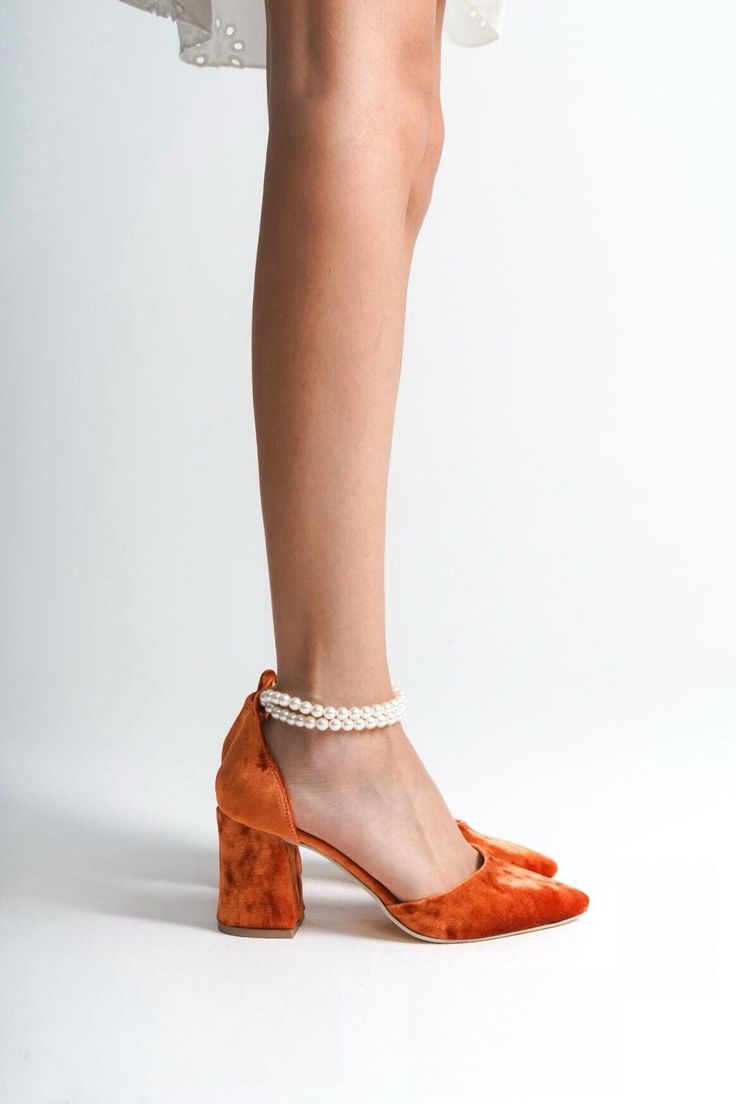 ORANGE VELVET SHOES, ORANGE WEDDING SHOES, ORANGE SHOES, ORANGE HIGH HEELS, ORANGE BLOCK HEELS, ORANGE BRIDAL SHOES, ORANGE HEELS As Eleanor Louise, we stand out with our Orange heeled shoes that combine style and comfort. Specifically designed for brides, these shoes are crafted with high-quality materials. * Made from Orange Velvet and Premium Vegan Leather, our shoes are equipped with an ankle strap that provides comfort throughout the day. * Completing your style and boosting your confidence is the most elegant way! Orange Velvet 3.15-inch (8 cm) high-heeled shoes offer elegance and chicness with every step. Whether it's for daily wear or a special event, these shoes not only add height but also provide a sophisticated touch to your style. * Their classic and elegant design perfectly c Orange Velvet Shoes, Orange Low Heel Party Heels, Orange Closed Toe Elegant Heels, Elegant Orange Closed Toe Heels, Orange Almond Toe Heels For Party, Party Orange Almond Toe Heels, Elegant Orange Ankle Strap Heels, Elegant Orange Pointed Toe Heels, Elegant Orange Heels With Wrapped Heel