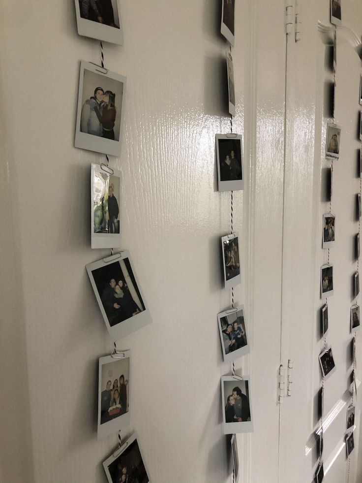 a wall with pictures hanging on it's sides and photos hung to the side