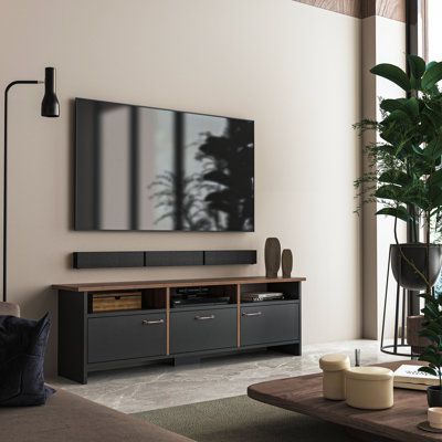 a large flat screen tv mounted to the side of a wall in a living room