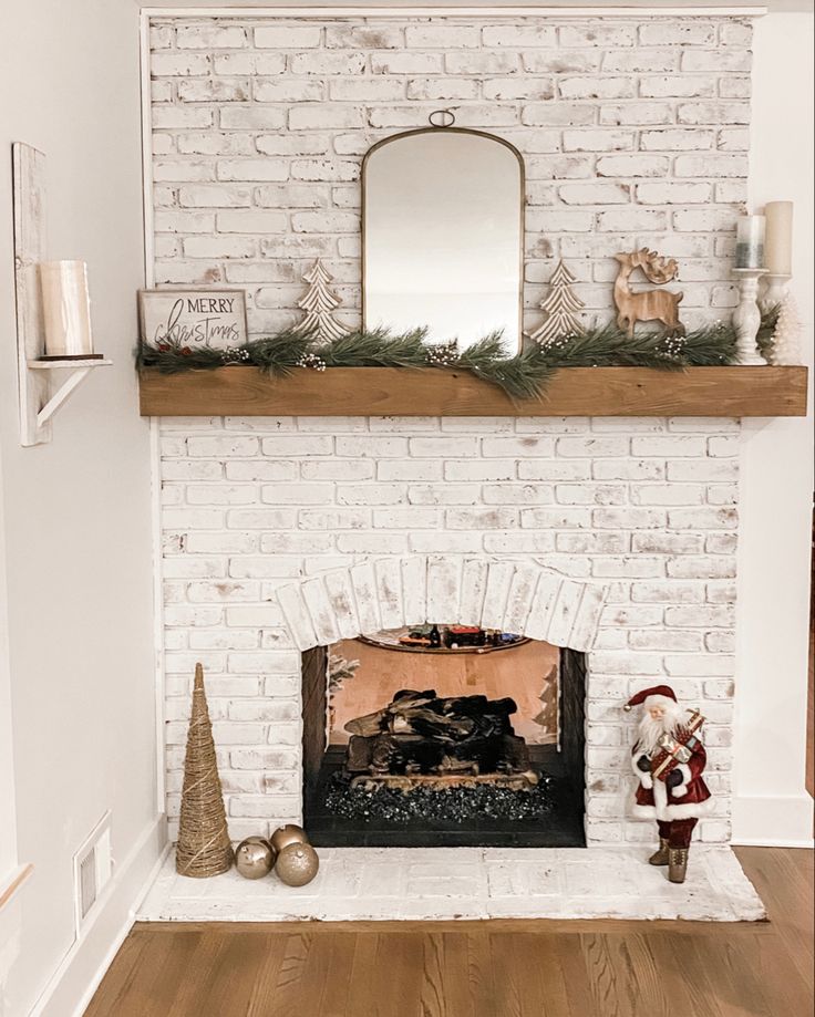 a white brick fireplace with christmas decorations on top