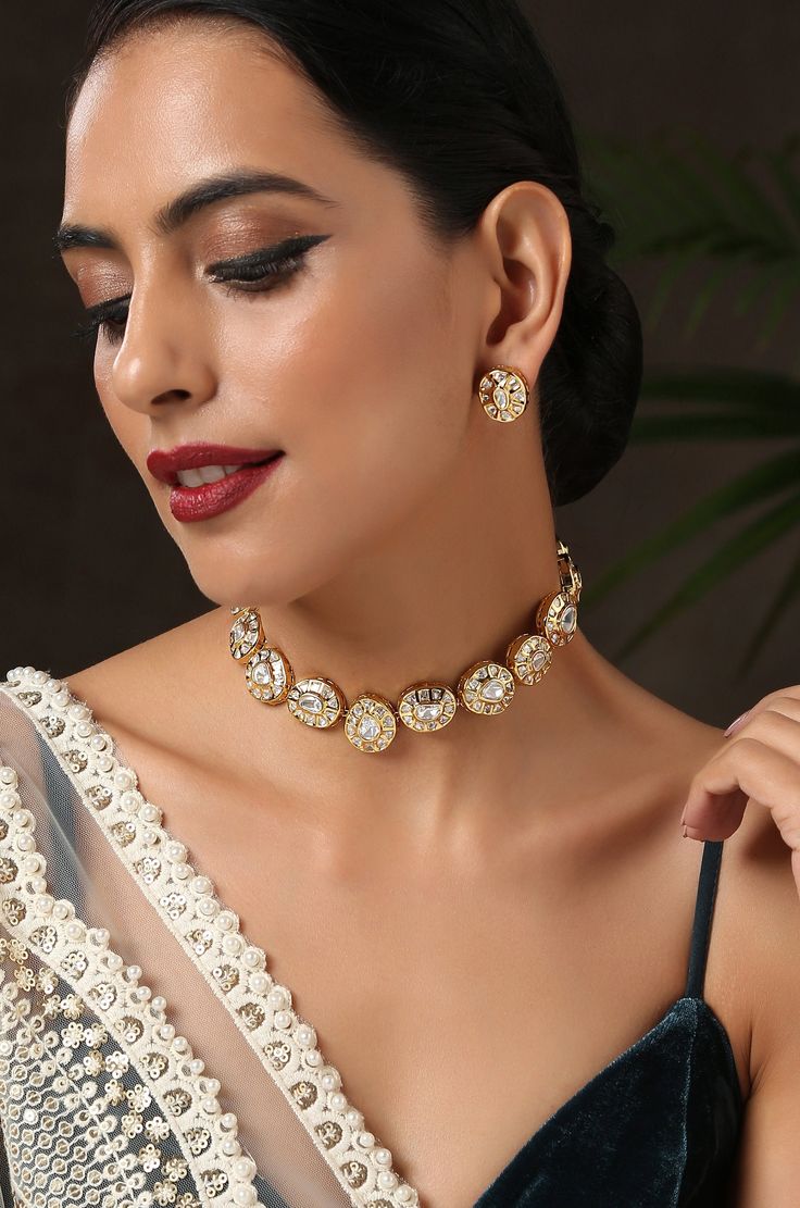 This choker necklace set is an edgy piece with a geometrical deisgn. The timeless kundan in a backdrop of glorious gold plated silver alloy is a very pretty modern piece. Necklace Closure - Adjustable Dori Earrings Closure - Push Back Style Tip - Versatility and elegance being the strong suit, we leave a lot to your imagination for how you want to dress your jewels your way and embracing your personal style. This pretty is made for a modern day woman who has her heart in the little details of he Gold Meenakari Jewelry Sets, Metal Kundan Choker Necklace As A Gift, Bollywood Style Gold Choker Necklace, Gold Metal Jewelry For Diwali, Festive Gold Plated Kundan Choker Necklace, Festive Gold-plated Kundan Choker Necklace, Gold Kundan Bollywood Style Necklace, Gold Bollywood Style Kundan Necklace, Gold Kundan Metal Necklace For Celebration