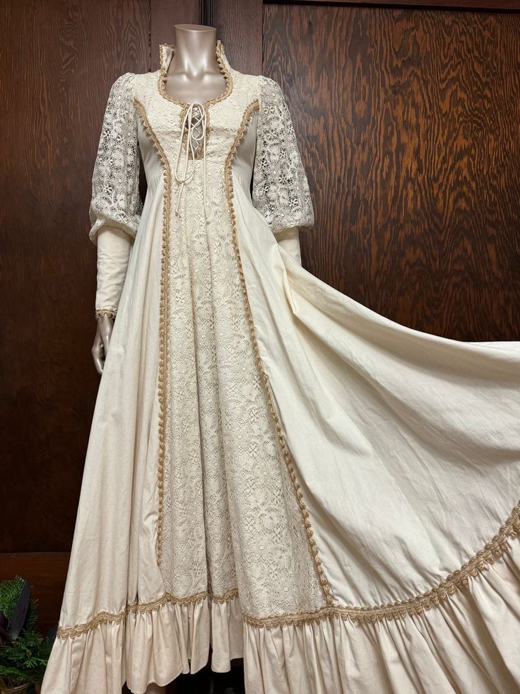 I love Gunnies for weddings!  This is in beautiful condition and would make a beautiful bride!   Please read measurements carefully before ordering.  Approximate size: XS (Label is size 5) B- 32" W-26" L-56" White Medieval Wedding Dress With Historical Design, White Historical Design Wedding Dress, Historical Lace Wedding Dress, Historical Design Prairie Dress For Wedding, Wedding Prairie Dress With Historical Design, Fitted Wedding Dress With Historical Design, Lace Wedding Dress With Historical Design, Victorian Wedding Dress With Empire Waist And Historical Design, Victorian Wedding Dress With Empire Waist