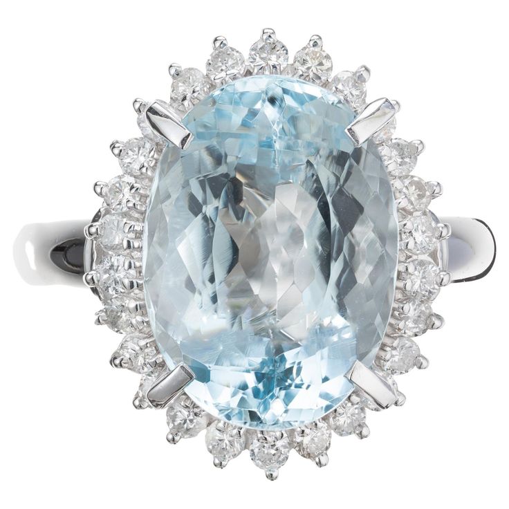 an oval blue topazte and diamond ring with two rows of diamonds surrounding it