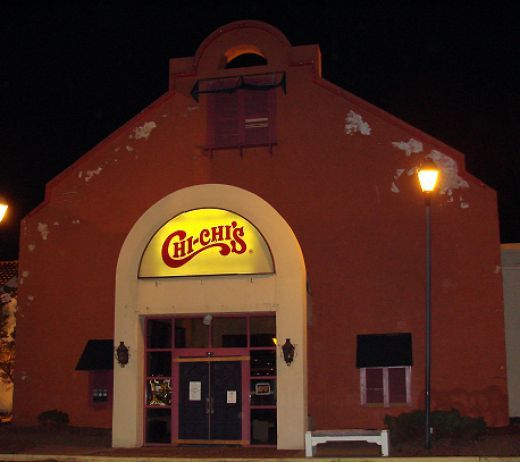 the front entrance to a restaurant at night