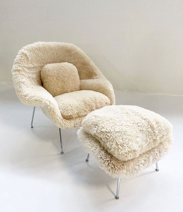 the chair and ottoman are all made out of sheepskin, with one foot resting on it