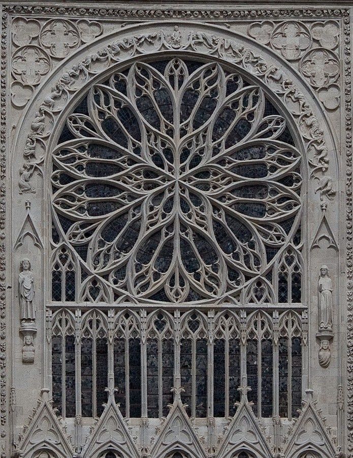 an intricately designed window on the side of a building