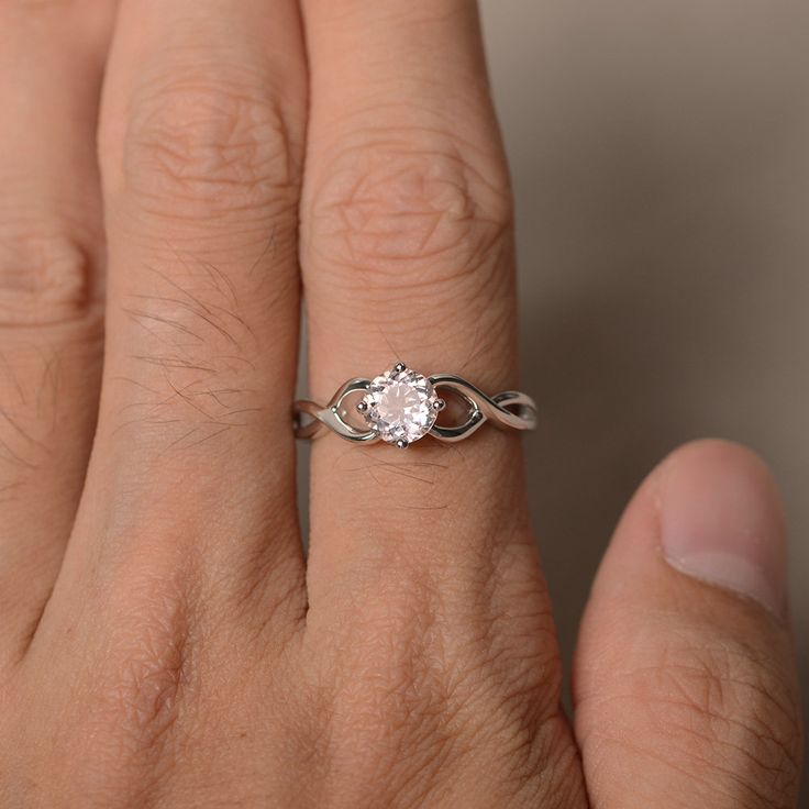 This is a gorgeous handmade creation. Its beauty is its simplicity & Elegance. The 6*6 mm round shape faceted natural Morganite is crafted in solid sterling silver and with rhodium plated. All item is sent in a beautiful gift box If you have any idea of design your ring,pls contact me directly. You can realize more lovely stuff clicking the link https://www.etsy.com/shop/knightjewelry?refshopsection_shophome_leftnav Please leave the correct address and you phone number for delivering success Minimalist Diamond White Ring With Center Stone, Minimalist Round Cut Promise Jewelry, Diamond White Infinity-shaped Jewelry With Diamond Cut, Infinity Shaped Diamond White Jewelry With Diamond Cut, Diamond White Infinity Jewelry With Diamond Cut, Minimalist Cubic Zirconia Wedding Ring, Diamond Cut Infinity Jewelry In Diamond White, Adjustable Solitaire Promise Rings, Minimalist White Gold Crystal Ring With Round Cut