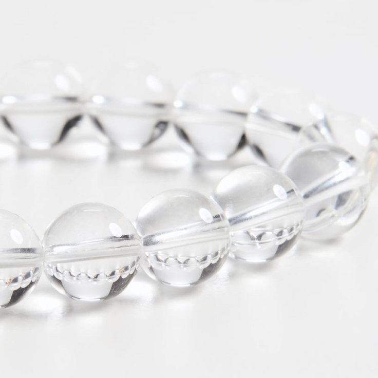 a close up of a bracelet on a white surface