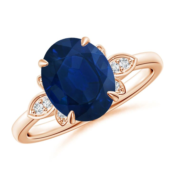 an oval blue sapphire and diamond ring with two diamonds on the band, set in 18k rose gold